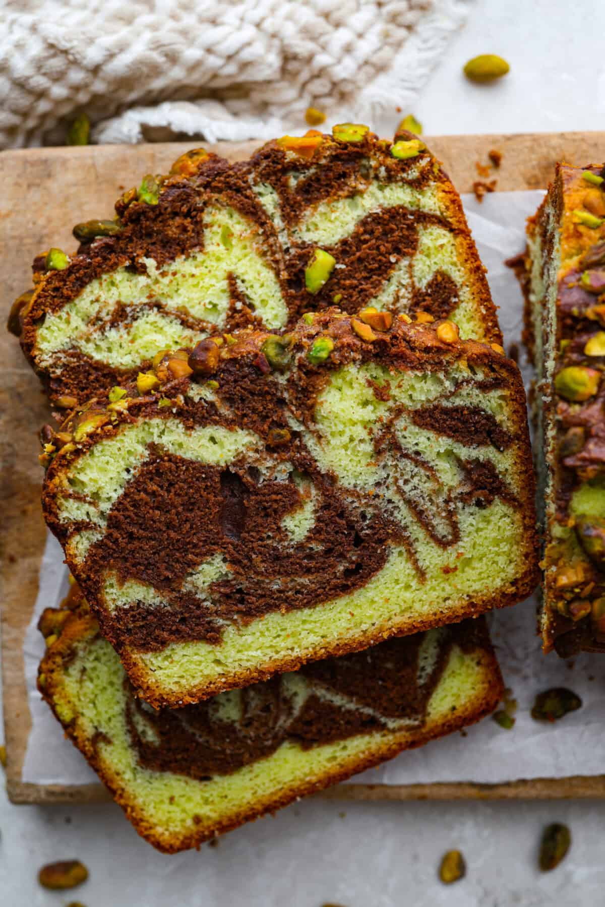 Starbucks dropped a new Chocolate Pistachio Loaf, and I was instantly obsessed. The pistachio flavor and that rich chocolate swirl had me determined to make a copycat at home so I could skip the drive-thru and bake it anytime. Chocolate pistachio loaf sliced and laying on its' side on a cutting board.
