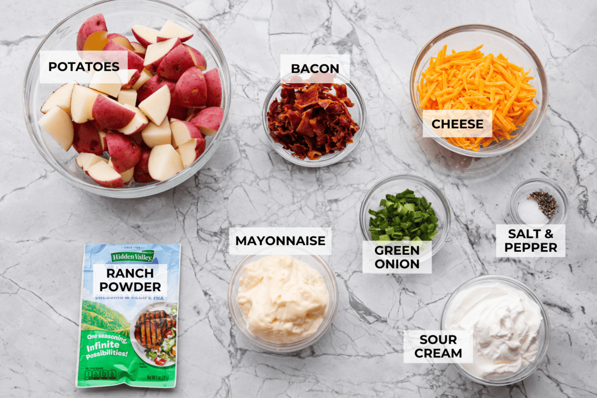 Overhead shot of labeled crack potato salad ingredients. 