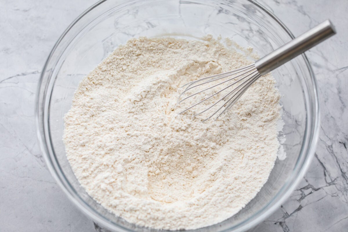 These cinnamon roll butter swim biscuits are my cheat code to making "cinnamon rolls." They bake up soft and fluffy with a sweet cinnamon swirl and icing on top. They disappear almost as fast as you can make them! Dry ingredients added to a large mixing bowl.