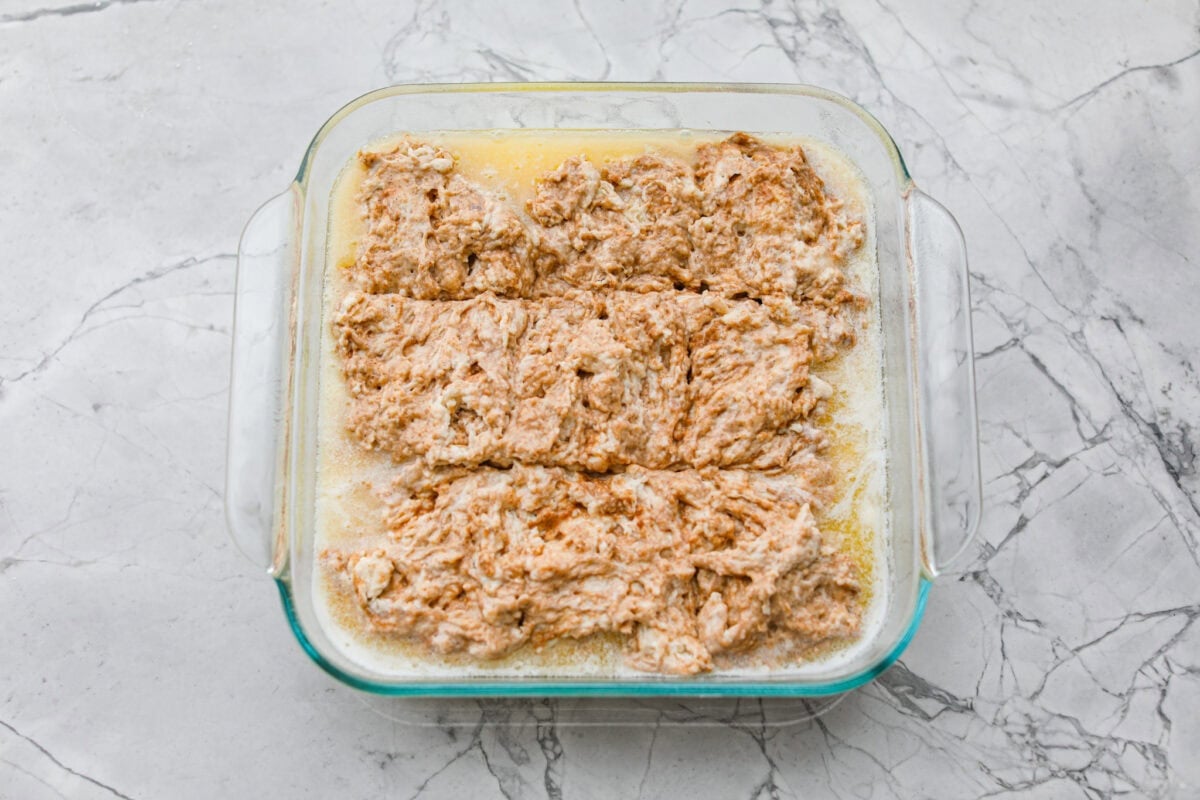 These cinnamon roll butter swim biscuits are my cheat code to making "cinnamon rolls." They bake up soft and fluffy with a sweet cinnamon swirl and icing on top. They disappear almost as fast as you can make them! Biscuit mixture scored into 9 pieces.