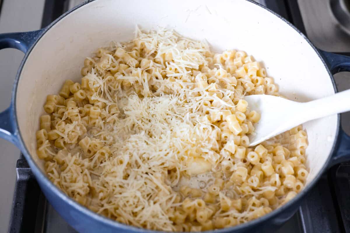 Cheese and butter added to the pan to be stirred in with the cooked pasta. 