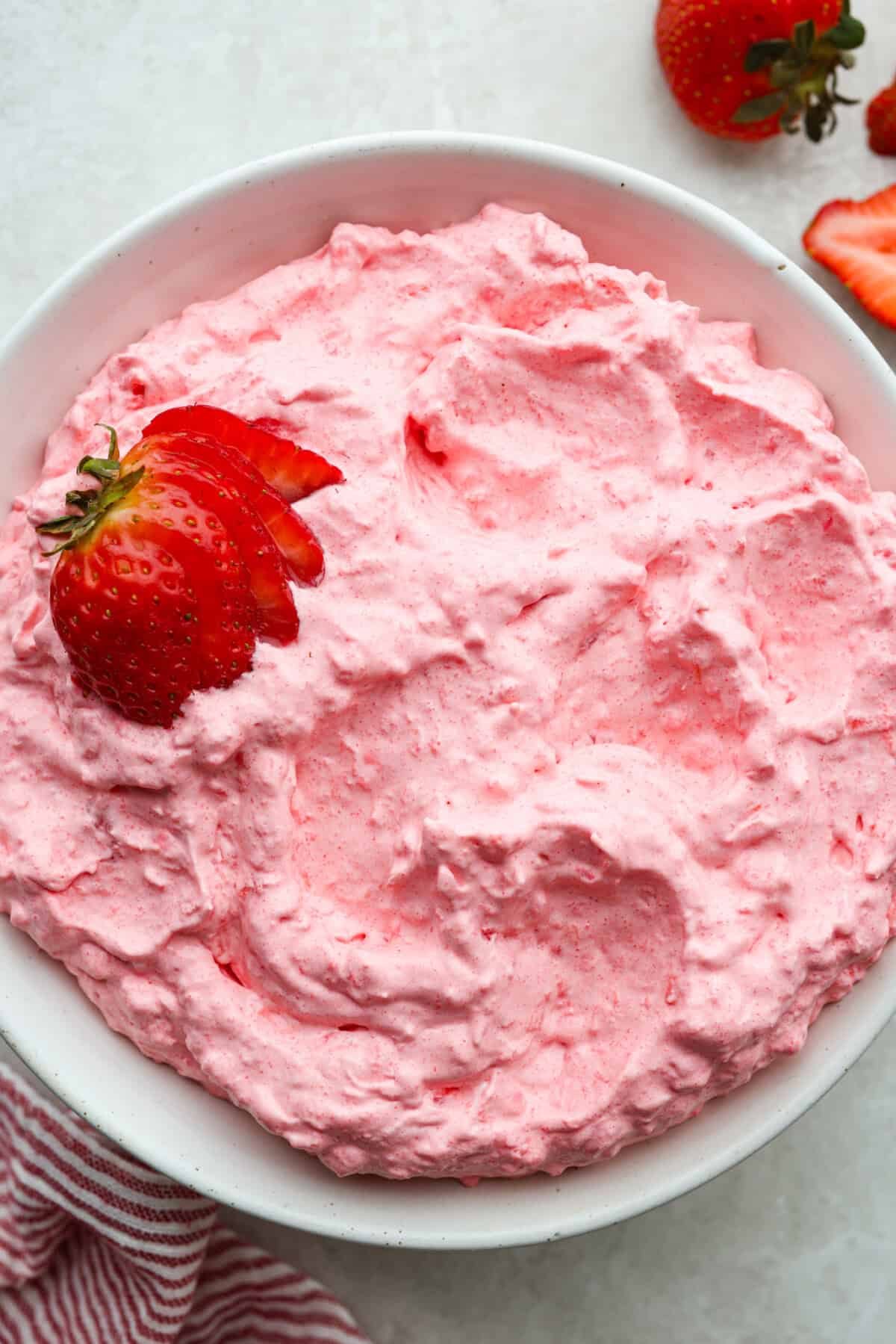 This cottage cheese jello salad is one of those old-school recipes that never really goes out of style. My dad absolutely loves it and requests it all the time, especially for family get-togethers. It’s creamy, fruity, and ridiculously easy to make. Bowl of strawberry cottage cheese Jello salad.