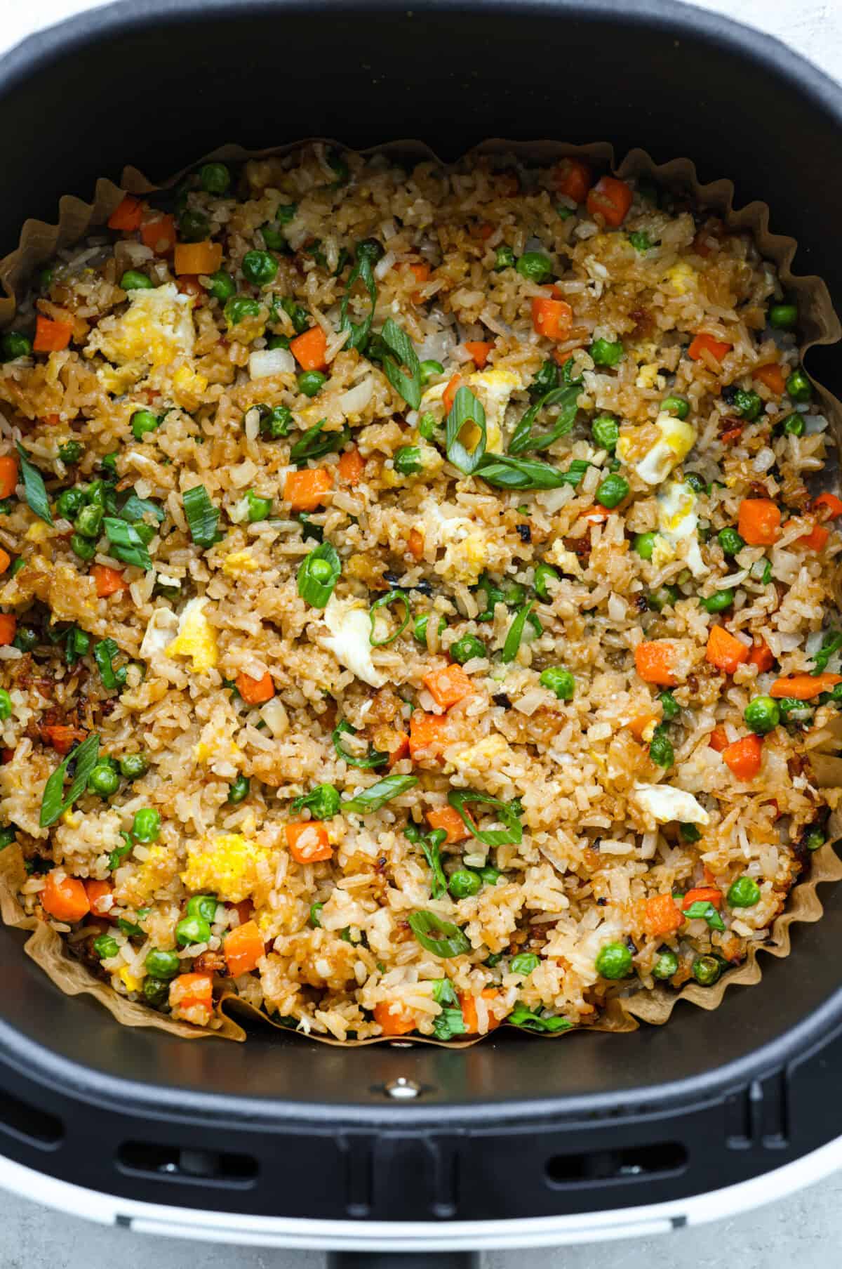 Overhead shot of fried rice in the air fryer basket. 