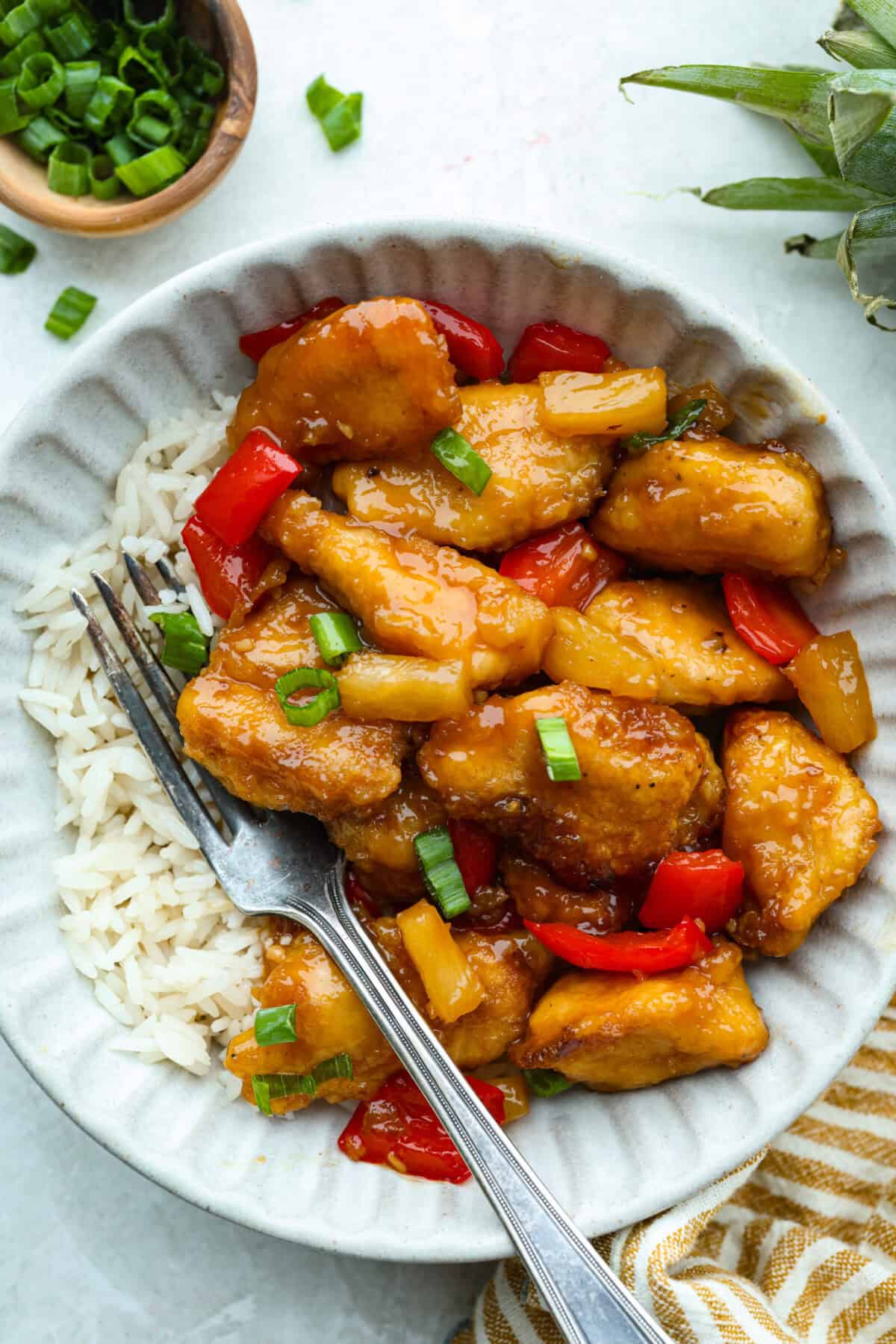 Serving of baked sweet Hawaiian chicken on a bed of rice. 