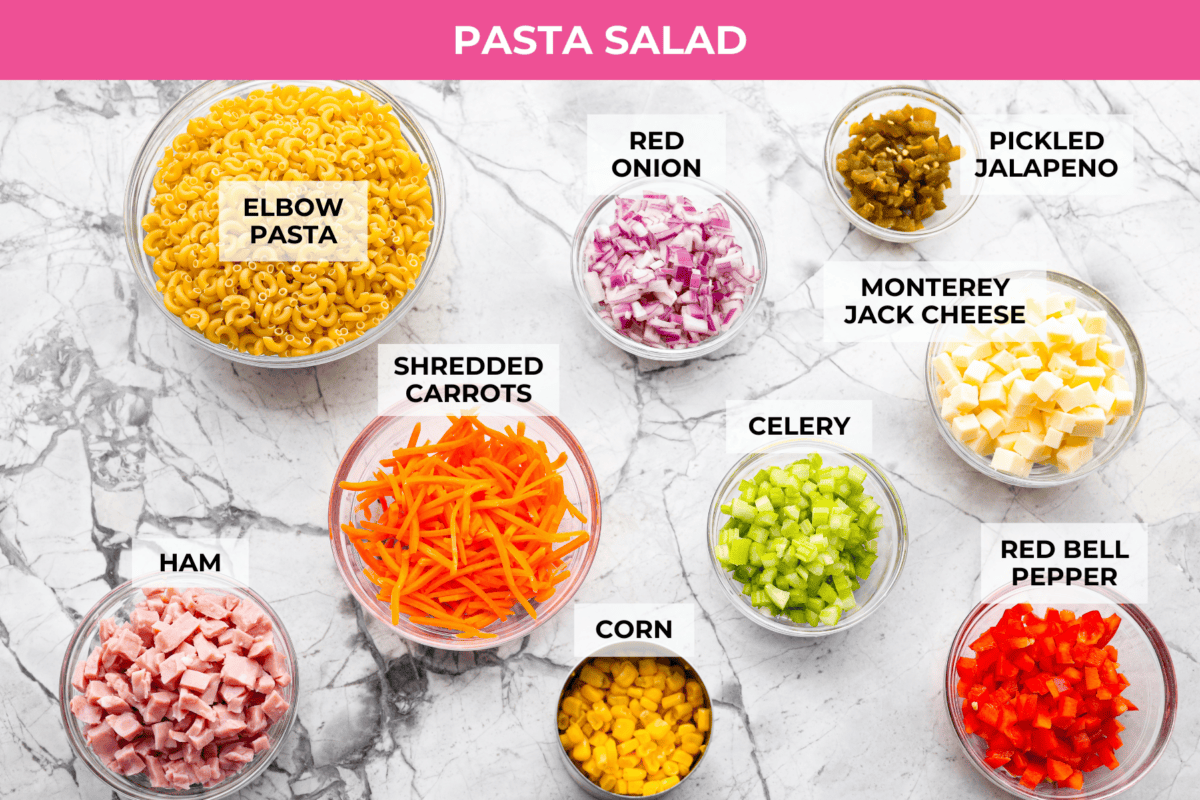 Overhead shot of labeled pasta salad ingredients. 