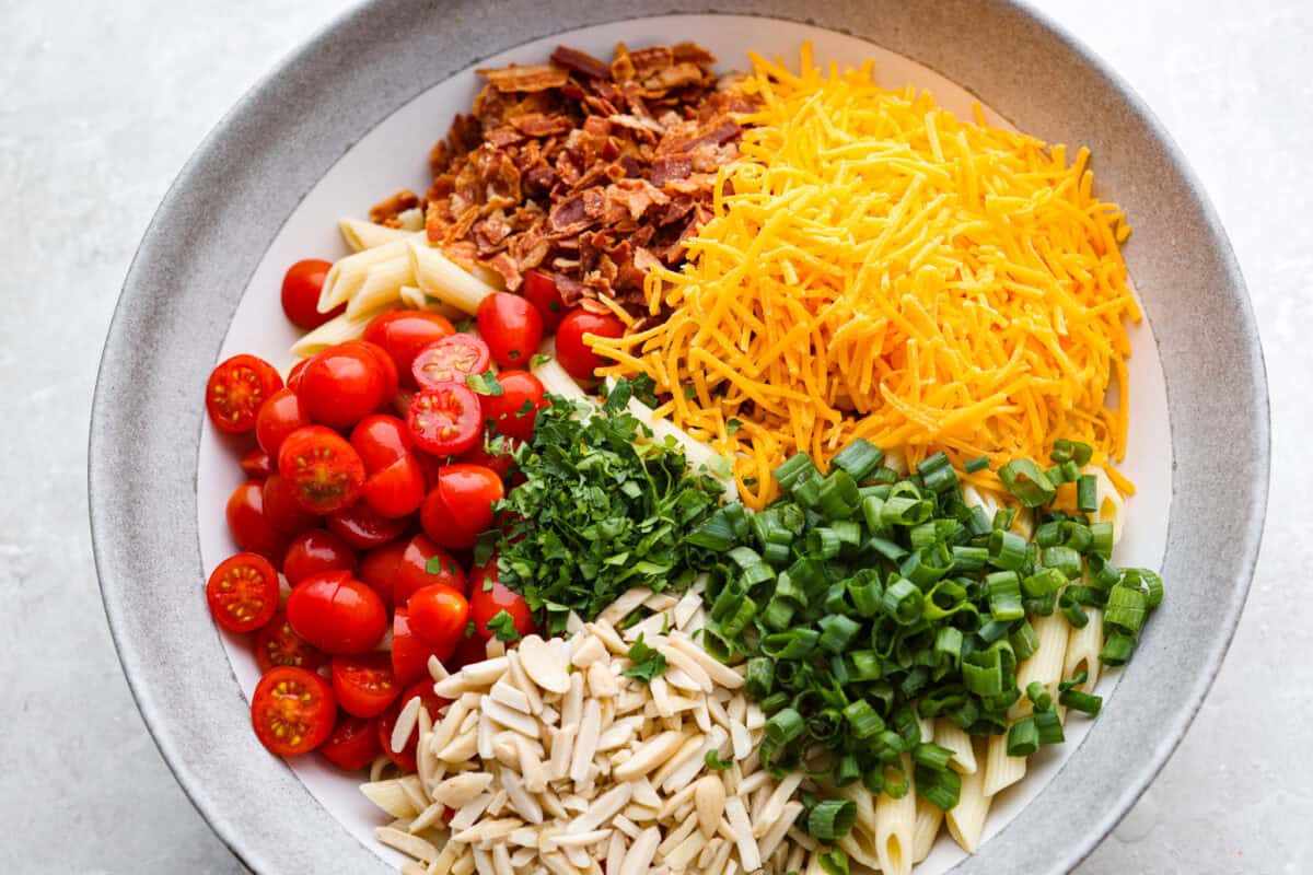 All of the salad ingredients added to a large bowl. 