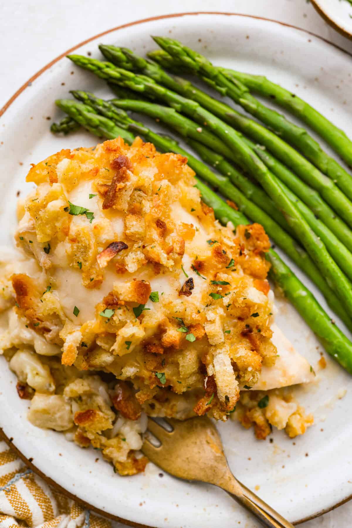 Okay, this Swiss Chicken Casserole is my go-to when I don’t feel like cooking. You basically throw it together, pop it in the oven, and somehow end up with super tender chicken, melty Swiss cheese, and the creamiest sauce. Swiss chicken plated next to some green beans!