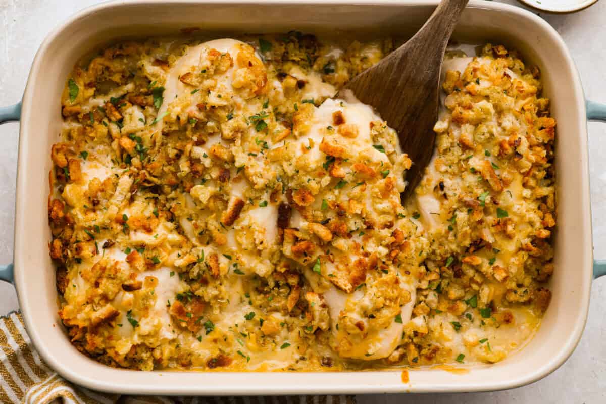Okay, this Swiss Chicken Casserole is my go-to when I don’t feel like cooking. You basically throw it together, pop it in the oven, and somehow end up with super tender chicken, melty Swiss cheese, and the creamiest sauce. Swiss chicken in a baking dish all ready to be served.